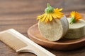 Natural organic calendula solid shampoo, calendula flower and wooden comb.