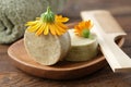 Natural organic calendula solid shampoo pieces, calendula flowers, wooden hair comb and towel. Royalty Free Stock Photo