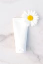 Natural organic cosmetic packaging mock up with flowers of camomile. Hand cream or lotion for softening skin Royalty Free Stock Photo