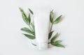 Natural organic cosmetic packaging plastic mock up with leaves and flowers. Mock-up bottle for branding and label.