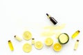 Natural organic cosmetics with lemon. Lemon oil or lotion, spa salt in small bottles on white background top view copy Royalty Free Stock Photo