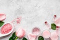 Natural organic cosmetics with rose oil. Cream, lotion, spa salt on grey background top view copyspace Royalty Free Stock Photo