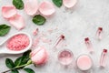 Natural organic cosmetics with rose oil. Cream, lotion, spa salt on grey background top view copyspace Royalty Free Stock Photo