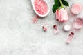 Natural organic cosmetics with rose oil. Cream, lotion, spa salt on grey background top view copyspace Royalty Free Stock Photo