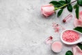 Natural organic cosmetics with rose oil. Cream, lotion, spa salt on grey background top view copyspace Royalty Free Stock Photo