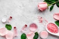 Natural organic cosmetics with rose oil. Cream, lotion, spa salt on grey background top view copyspace Royalty Free Stock Photo