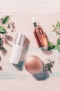 Natural organic cosmetics: serum, cream, mask on wooden background with flowers. Skincare concept