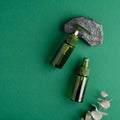 Natural organic cosmetics set on green background. Herbal beauty products, spa skincare concept. Flat lay, top view