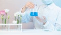 Natural organic extraction flower aroma essence solution with scientist in lab. Biotechnology concept Royalty Free Stock Photo