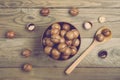 Natural organic macadamia nuts in bowl on wooden table Flat lay Top view Healthy snack Nuts contain essential oil rich in vitamins Royalty Free Stock Photo