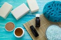 Natural organic soap bottles essential oil and sea salt herbal bath on a blue wooden table Royalty Free Stock Photo