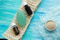 Natural organic soap bottles essential oil and sea salt herbal bath on a blue wooden table Royalty Free Stock Photo