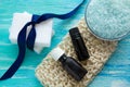Natural organic soap bottles essential oil and sea salt organic loofah on a blue wooden table Royalty Free Stock Photo