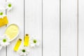 Natural organic spa cosmetics for skin care with chamomile. Spa salt, oil, soap on white wooden background top view copy