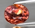 natural padparadscha orange sapphire gem on the background