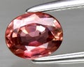 natural padparadscha orange sapphire gem on the background