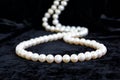 Natural pale pearl necklace on a black velvet Royalty Free Stock Photo