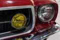 Close-up of the round headlamps of a red american classic car. Royalty Free Stock Photo