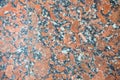 Natural pattern of polished red-gray granite facing plate. Royalty Free Stock Photo