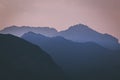 Natural patterns: layers of mountains in a foggy soft light at sunset. Garda Lake, Italy. Artistic, almost abstract Royalty Free Stock Photo