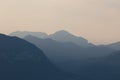 Natural patterns: layers of mountains in a foggy soft light at sunset. Garda Lake, Italy. Artistic, almost abstract Royalty Free Stock Photo