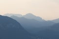 Natural patterns: layers of mountains in a foggy soft light at sunset. Garda Lake, Italy. Artistic, almost abstract Royalty Free Stock Photo