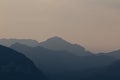Natural patterns: layers of mountains in a foggy soft light at sunset. Garda Lake, Italy. Artistic, almost abstract Royalty Free Stock Photo