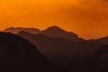 Natural patterns: layers of mountains in a foggy soft light at sunset. Garda Lake, Italy. Artistic, almost abstract Royalty Free Stock Photo