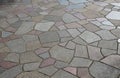 Natural paving of gneiss and granite irregular stones folded into a beautiful pattern where larger stones are surrounded by smalle