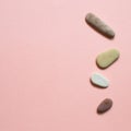 Natural pebble stones on pink background