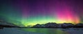 Natural phenomenon Aurora Borealis, colorful illuminating night sky Northern Light mountain range Royalty Free Stock Photo
