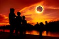 Natural phenomenon. Three looking at looking at total solar eclipse. Royalty Free Stock Photo