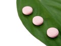 Natural pills and a green leaf Royalty Free Stock Photo