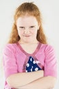 Natural Portrait of Caucasian Red-haired Angry Little Girl with