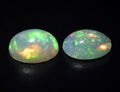 Natural precious stone noble opal on a gray background
