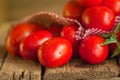 Long plum tomatoes with checkered red napkin on wooden table. Heap of fresh tomatoes Royalty Free Stock Photo