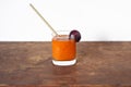 Natural products concept.Glass plum juice or smoothie with paper straw on wooden natural table