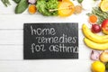 Natural products and slate board with text HOME REMEDIES FOR ASTHMA on wooden background Royalty Free Stock Photo