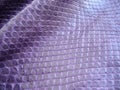 Natural python skin texture. Purple haberdashery snake skin. Royalty Free Stock Photo