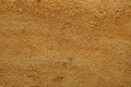 Natural quarry sand background. Grains of fine red sand close-up