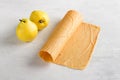 Natural quince pastille with fresh quince on a light gray background