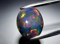 Natural rainbow multi color opal gem on the background