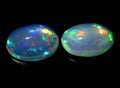 Natural rainbow multi color opal gem on the background