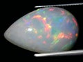 natural rainbow multi color opal gem on the background