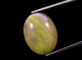 natural rainbow multi color opal gem on the background