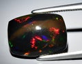 natural rainbow multi color opal gem on the background