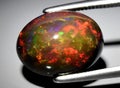 natural rainbow multi color opal gem on the background