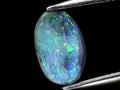 natural rainbow multi color opal gemstone on the background Royalty Free Stock Photo