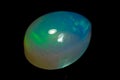 natural rainbow opal gem isolated on black background Royalty Free Stock Photo