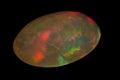 natural rainbow opal gem isolated on black background Royalty Free Stock Photo